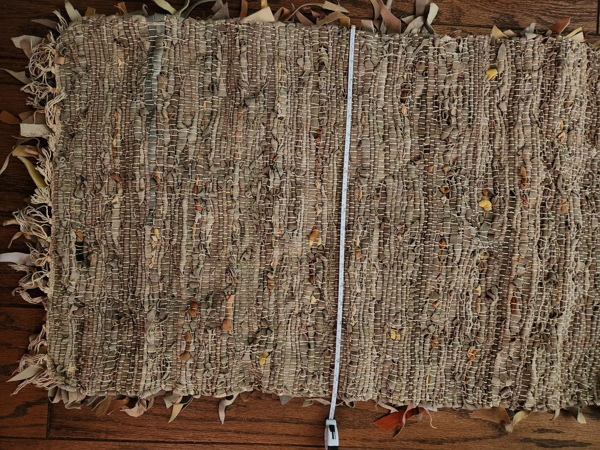 hand woven leather throw rug — woven detail Close-up of the woven leather underside of the throw rug, 20 by 32 inches