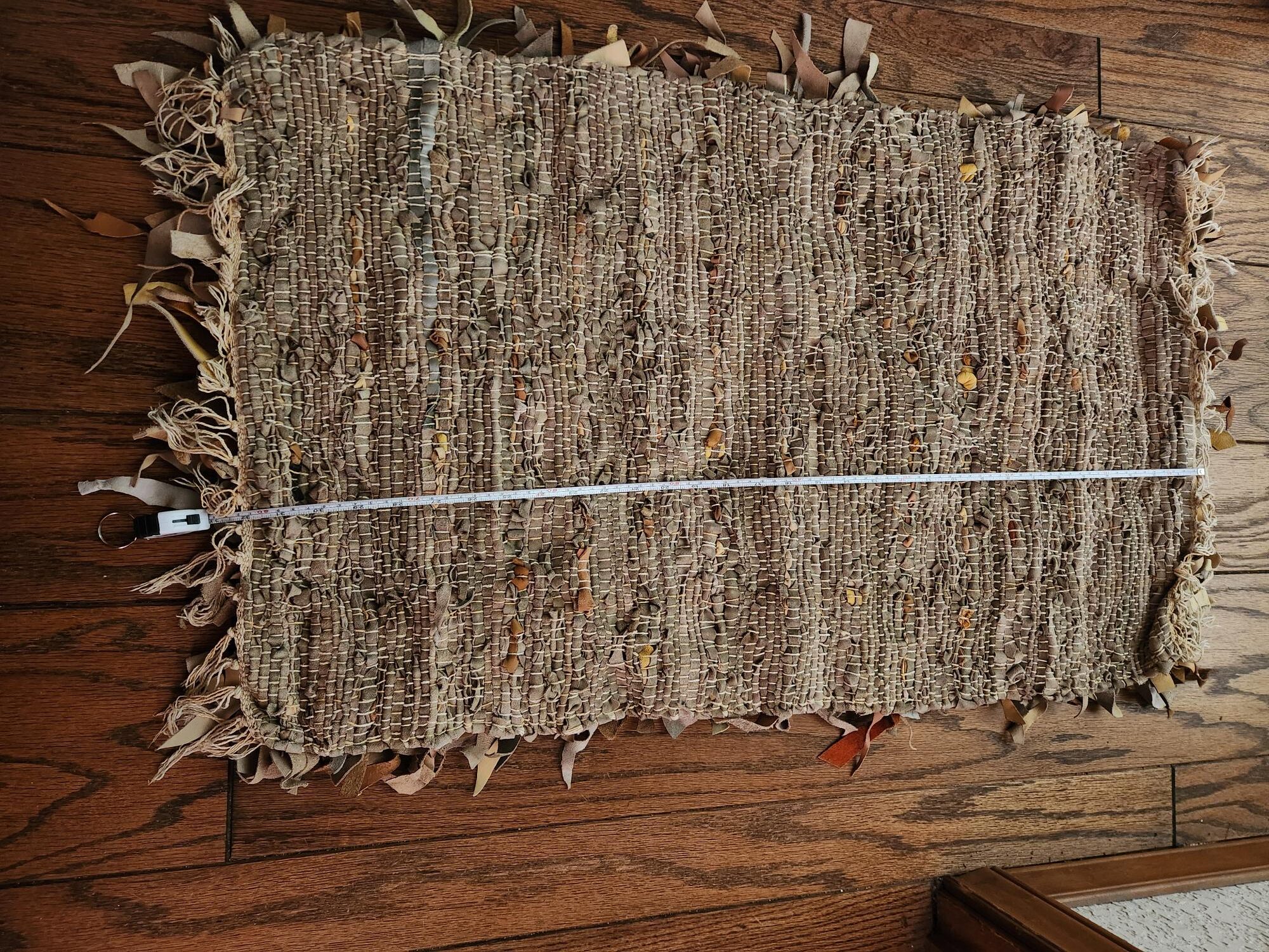 hand woven leather throw rug — woven detail Close-up of the woven leather underside of the throw rug, 20 by 32 inches